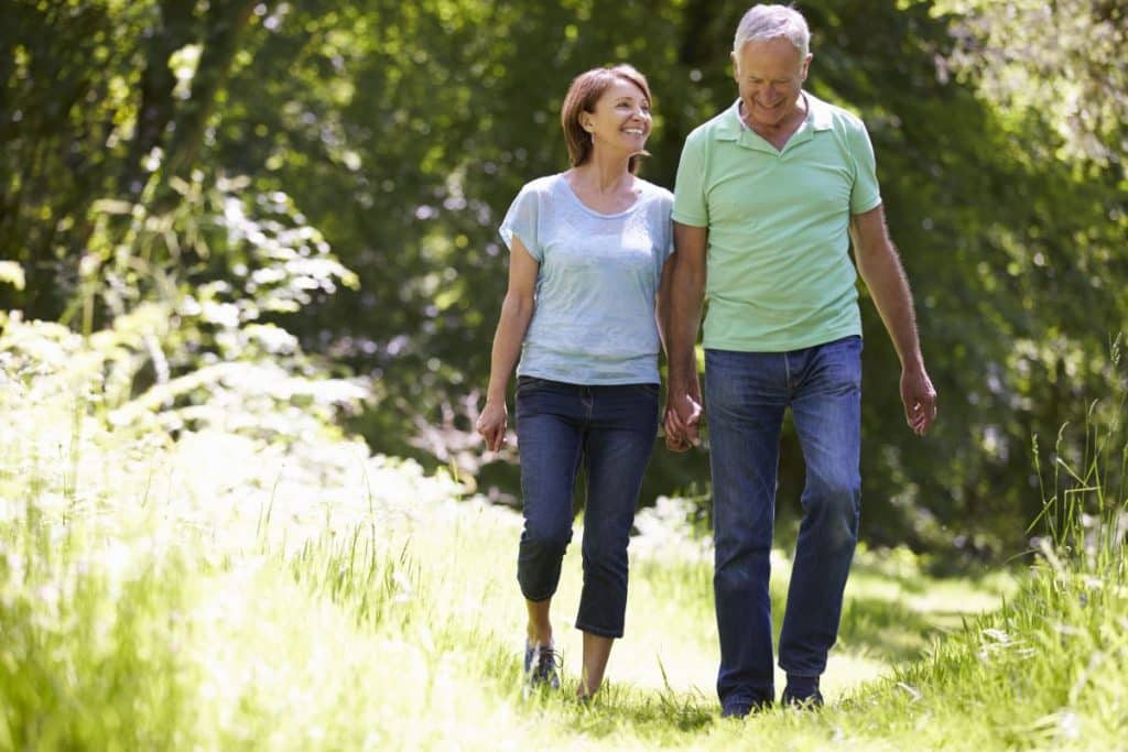 42270941 Senior Couple Walking In Summer Countryside